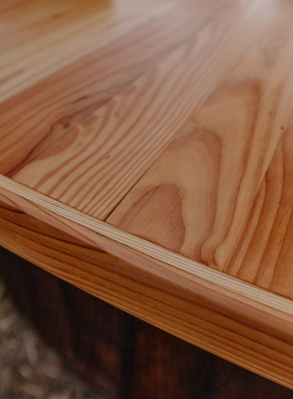 Close up detail of the dark wood semi-circle bar surface and craftsmanship