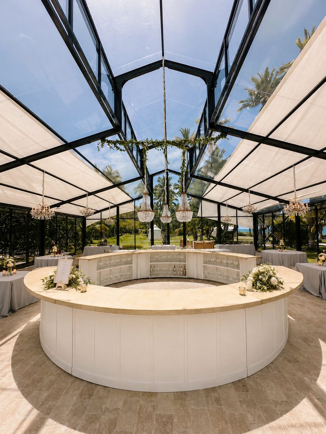 Full White Circle Bar under glass pavilion with crystal chandeliers at a luxury Oahu wedding